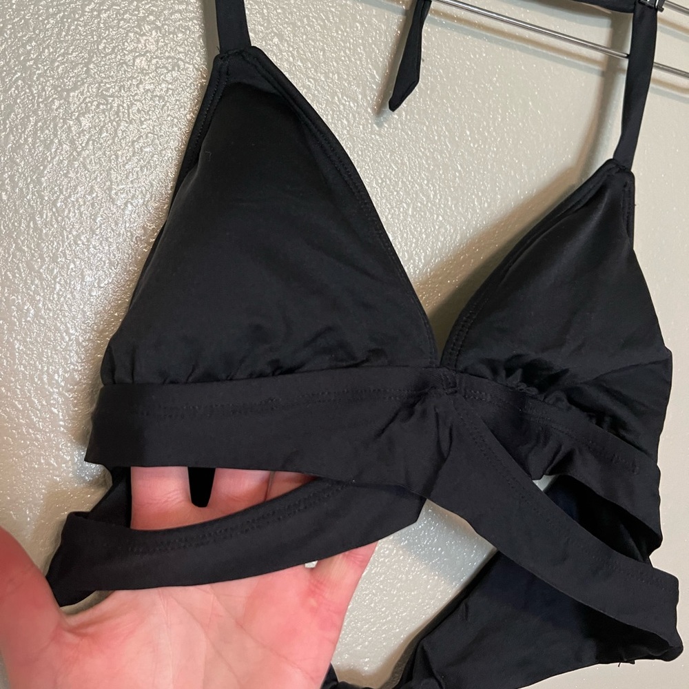 Black bikini top with side cutout detail, size medium, worn once